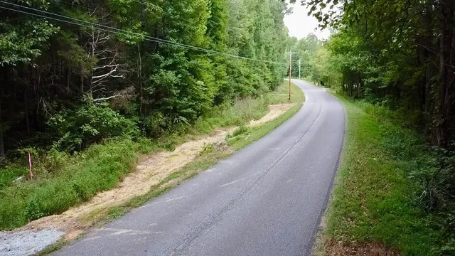 a view of a road with a yard and a fountain