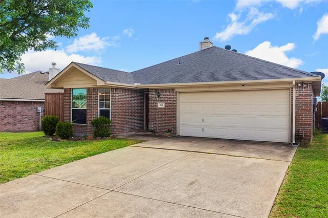 a front view of a house with a garden and yard
