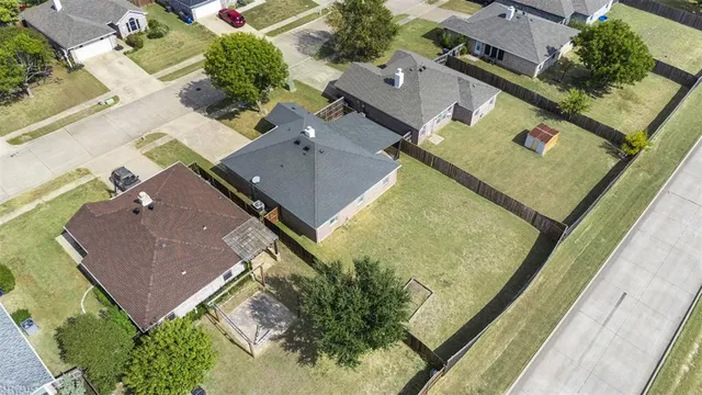 an aerial view of residential houses with outdoor space