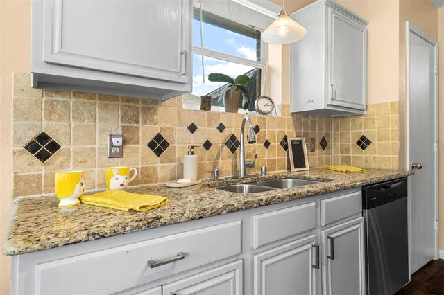 a kitchen with sink and cabinets