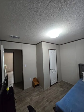 a view of a livingroom with wooden floor and closet