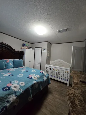 a bedroom with a bed and a dresser