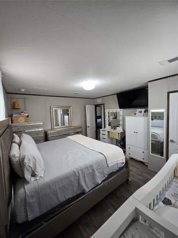 a bedroom with a large bed and a tv