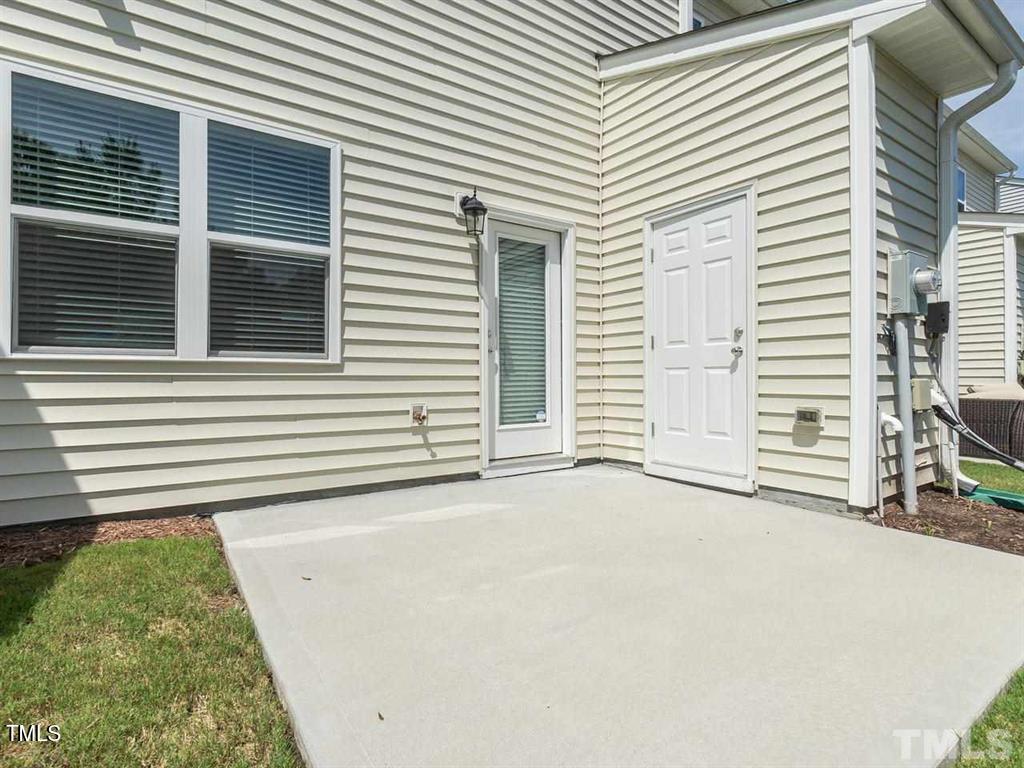 8862 Common Townes Drive Raleigh, NC 27616 - Photo 11 of 13 a view of a house with a yard and garage