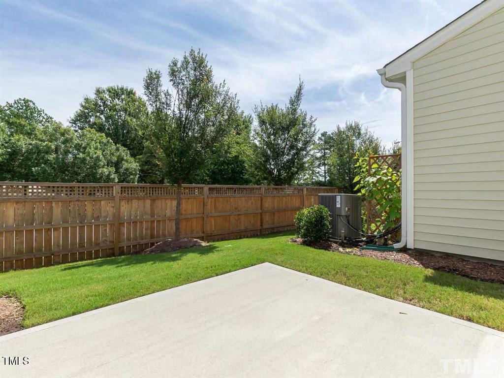 8862 Common Townes Drive Raleigh, NC 27616 - Photo 12 of 13 a view of a backyard with a garden