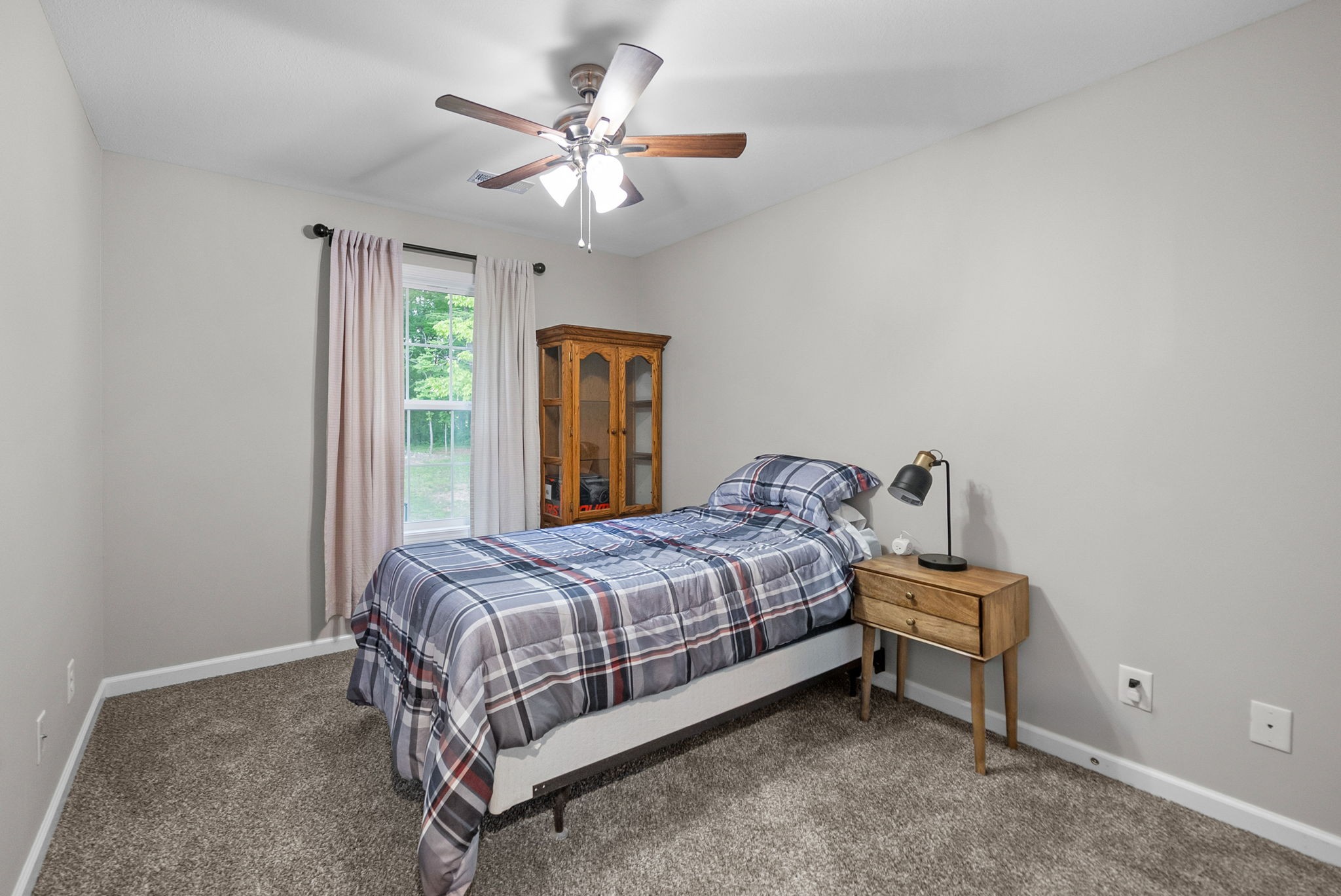 2685 Mockingbird Hill Road Palmyra, TN 37142 - Photo 29 of 47 a bedroom with a bed and a chandelier