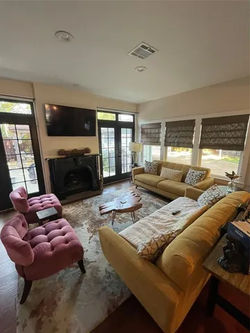 a living room with furniture large window and a fireplace