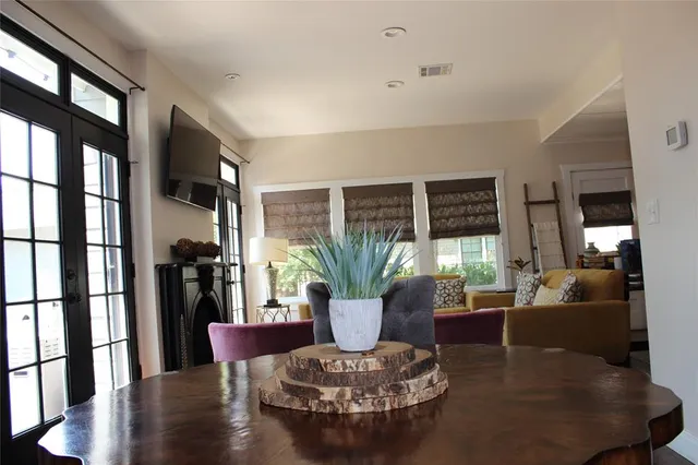a living room with furniture potted plant and a large window