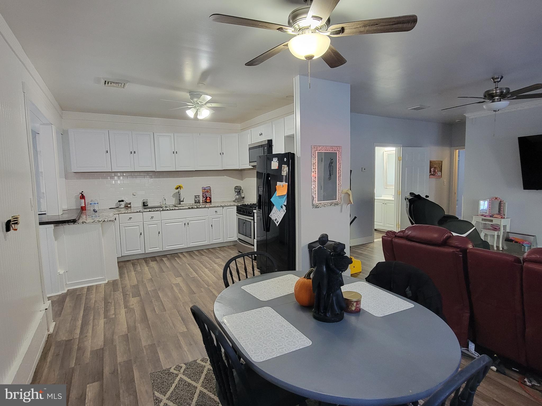 111 McKee Road Gibbsboro, NJ 08026 - Photo 50 of 62 a kitchen with stainless steel appliances granite countertop a sink dishwasher a dining table and chairs with wooden floor