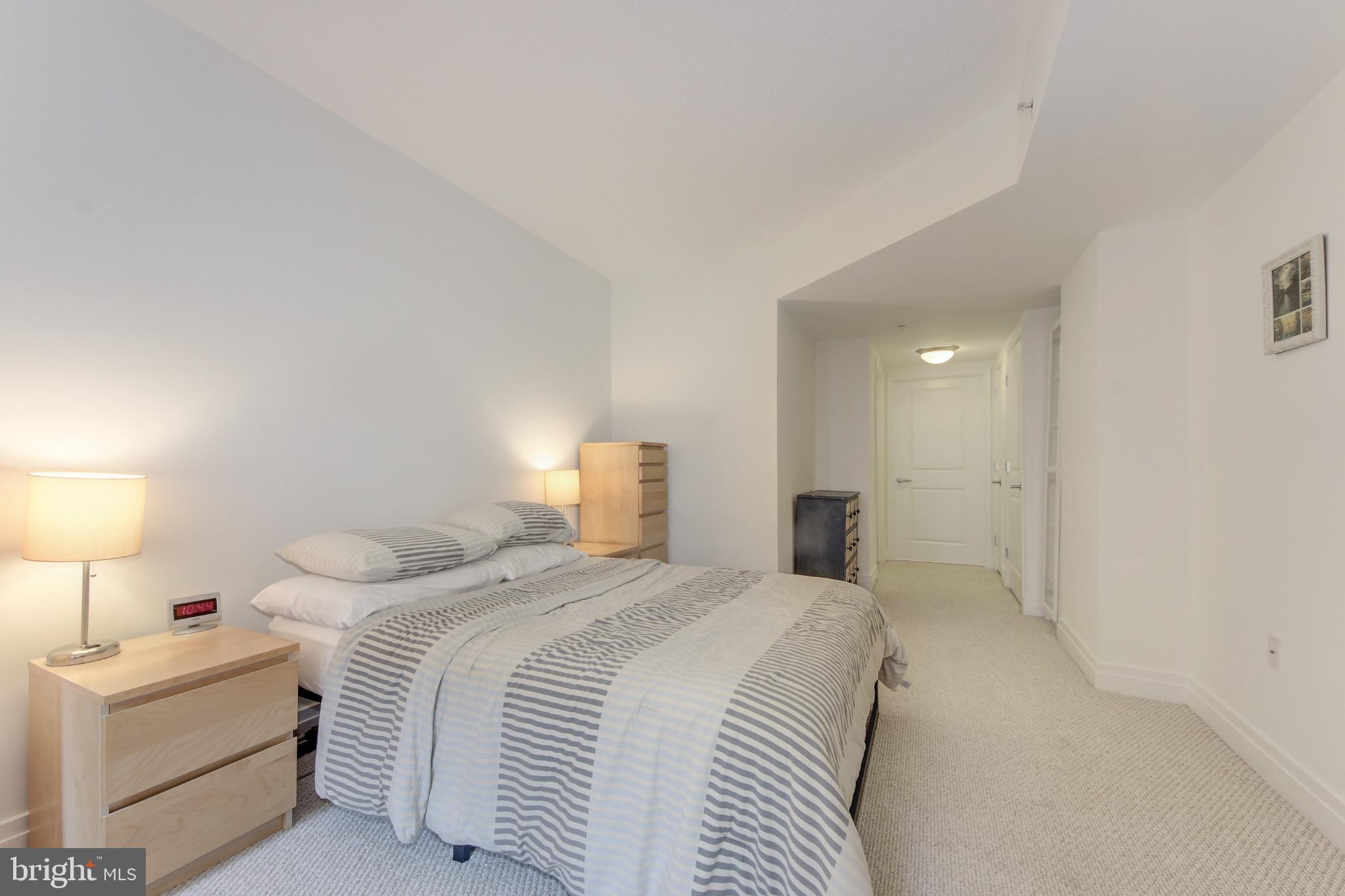 915 E Street Northwest, Unit 505 Washington, DC 20004 - Photo 14 of 35 Bedroom with en suite bathroom and laundry