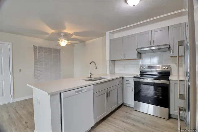 a kitchen with a sink stainless steel appliances and cabinets
