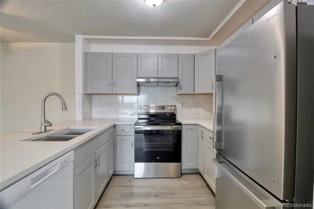 a kitchen with stainless steel appliances granite countertop a stove and a refrigerator