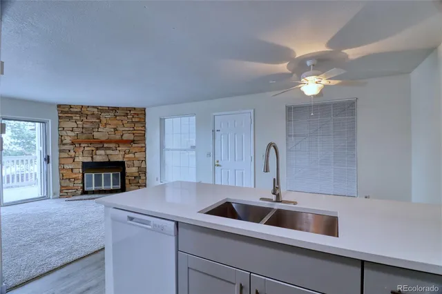 a kitchen with a sink and a fireplace