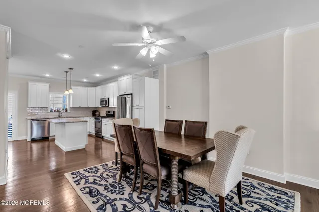a view of a dining room with furniture and wooden floor