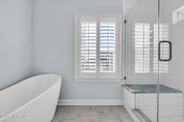 a bathroom with a bathtub and window