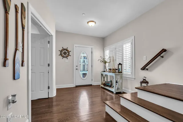 a view of a livingroom with furniture and hardwood floor
