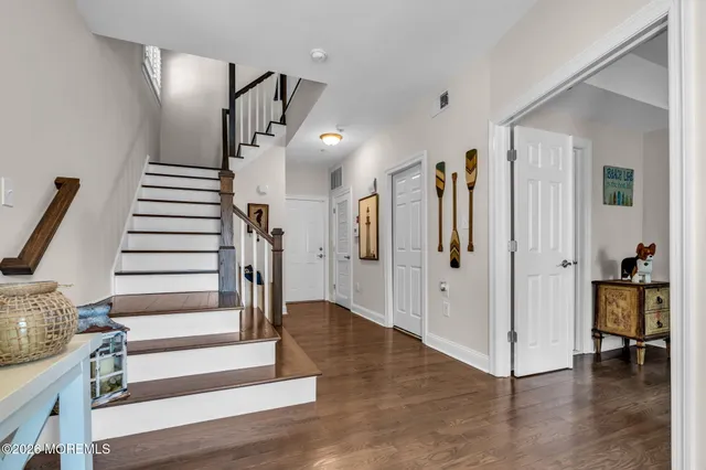 a view of entryway with furniture and wooden floor