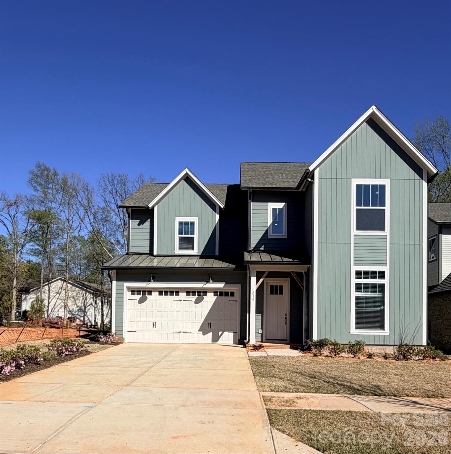 a view of a house with a yard and garage