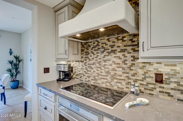 a kitchen with a table a sink and chairs