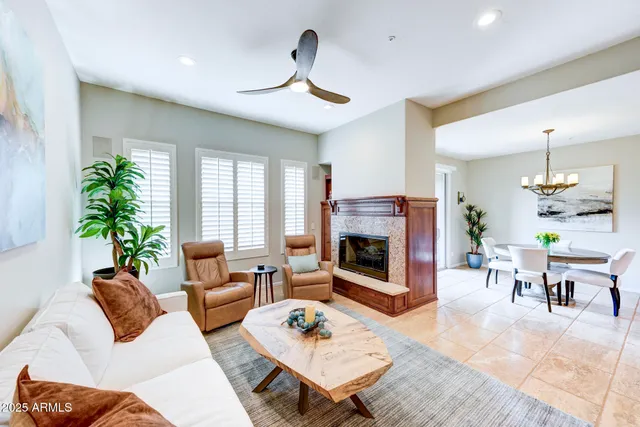 a living room with furniture potted plant and a large window