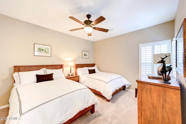a bathroom with a granite countertop shower sink and mirror