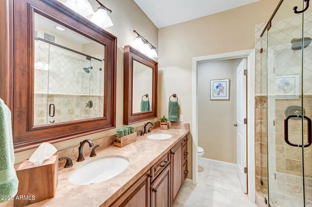 a bedroom with two large bed and a window