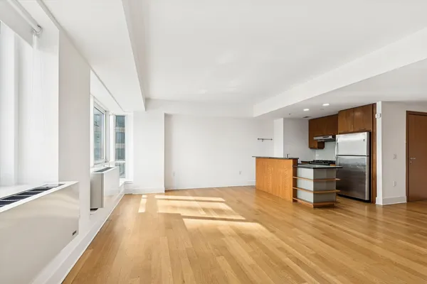 a large space with a lot of cabinets and wooden floor