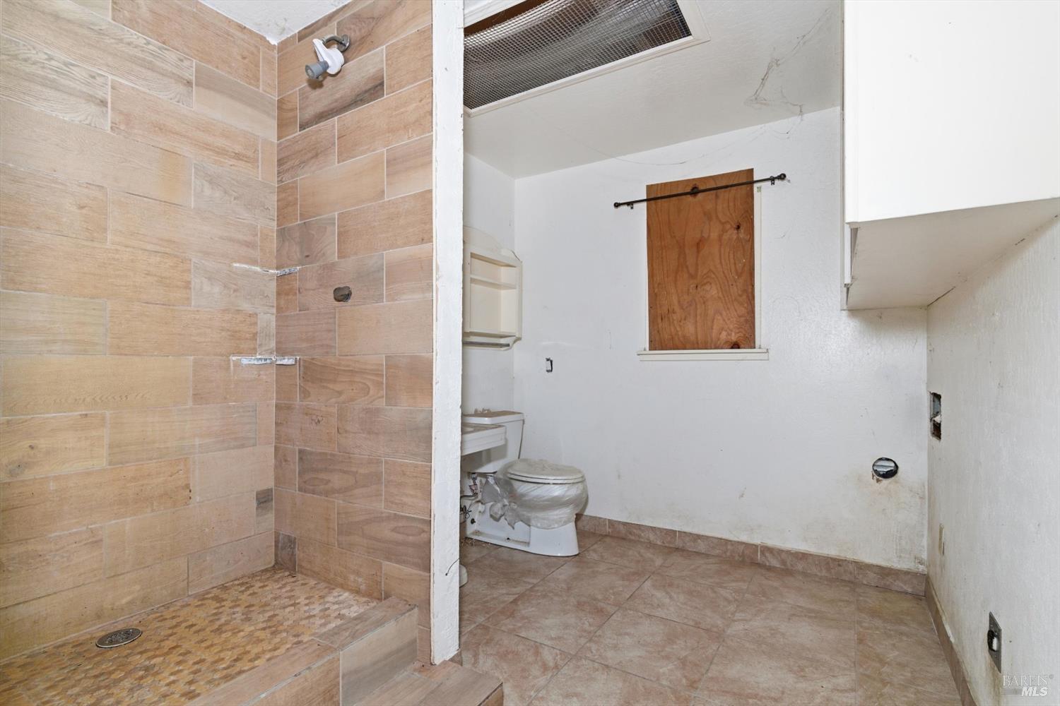 5140 Sharp Road Calistoga, CA 94515 - Photo 7 of 28 a bathroom with a granite countertop shower a toilet and a sink