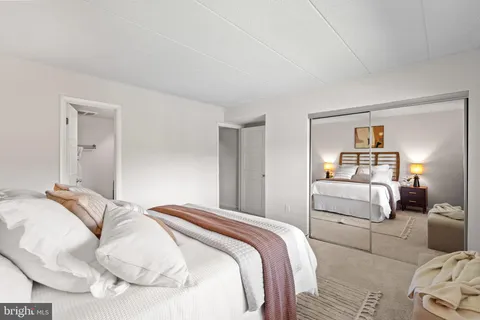 a bedroom with a bed and a large window