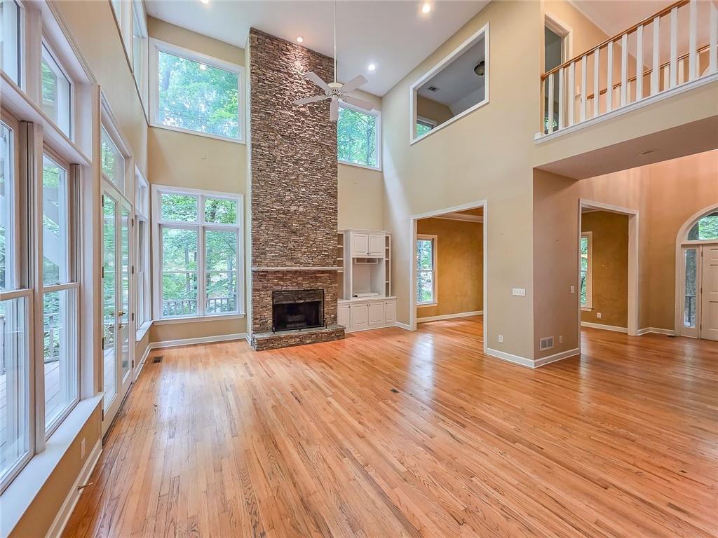3712 Frederica Road Northwest Berkeley Lake, GA 30096 - Photo 12 of 49 a view of empty room with wooden floor and fireplace