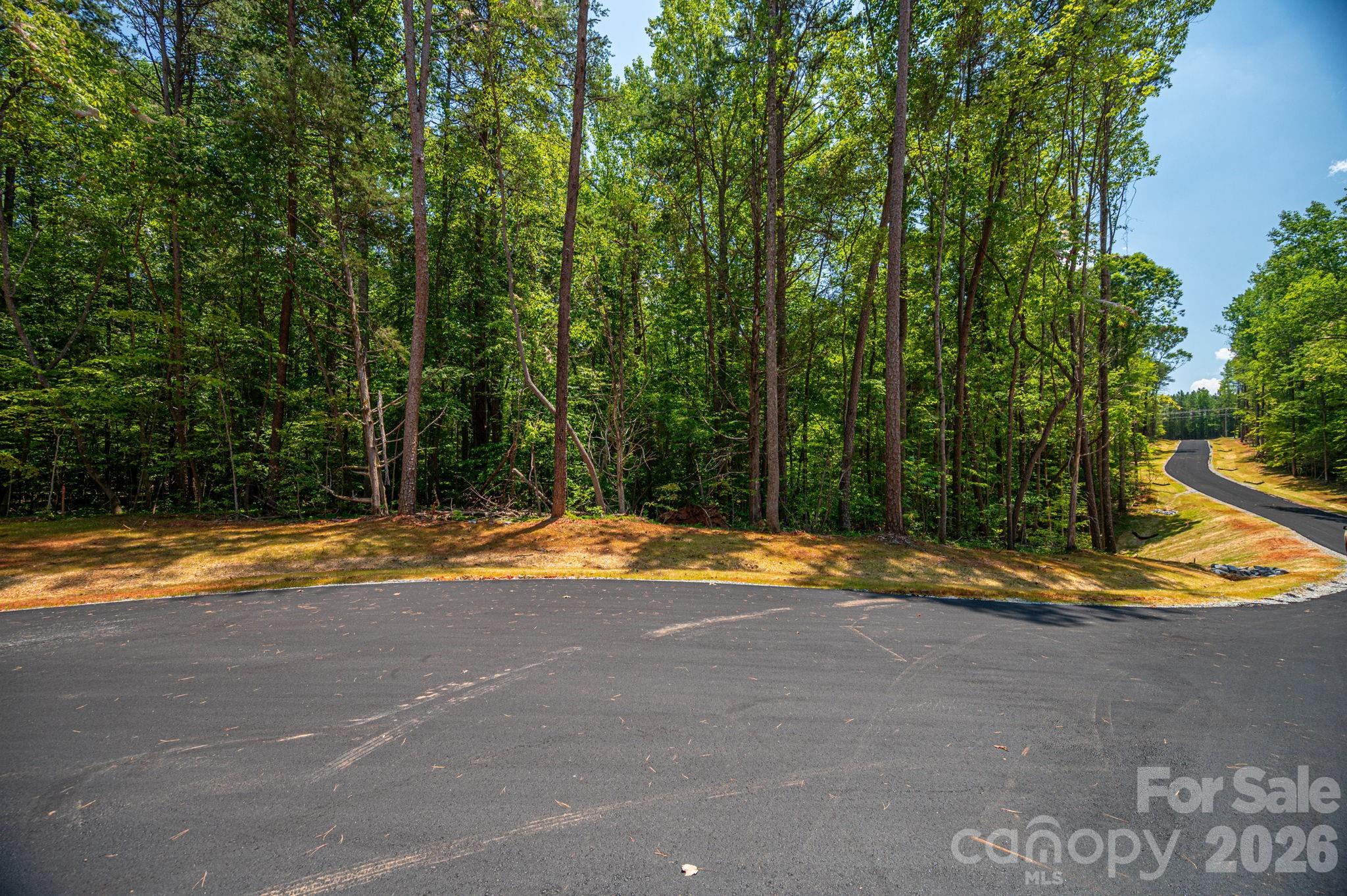 0 Oak Hill, Unit 13B Denver, NC 28037 - Photo 2 of 14 a view of a swimming pool with an outdoor space and seating area
