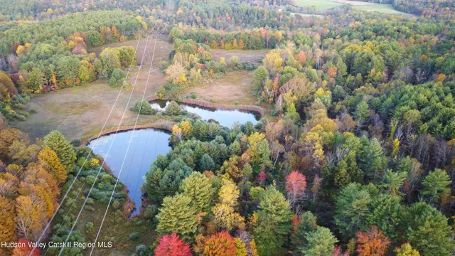 an aerial view of lake and residential houses with outdoor space