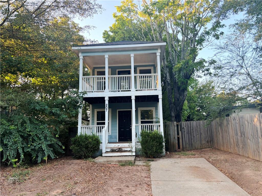 207 Fletcher Street Southwest Atlanta, GA 30315 - Photo 1 of 1 a view of house with a yard and potted plants