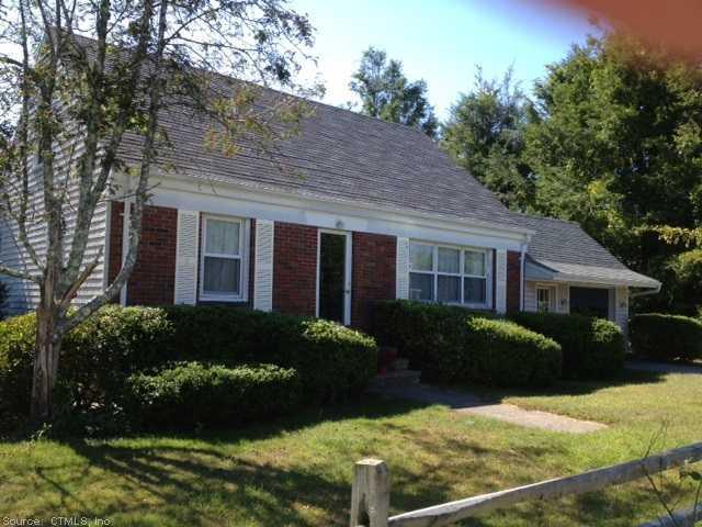 5 Geiser Street Stonington, CT 06355 - Photo 1 of 1 a front view of a house with a yard and potted plants