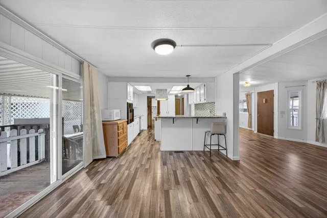 a view of a livingroom with wooden floor and closet
