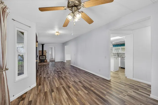 a bedroom with a bed and large windows