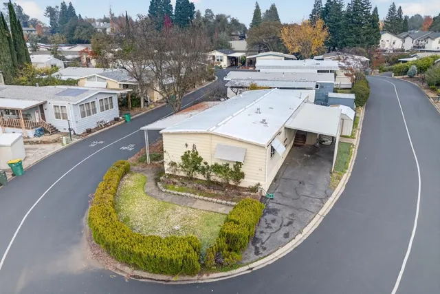 a view of backyard with swimming pool and seating space