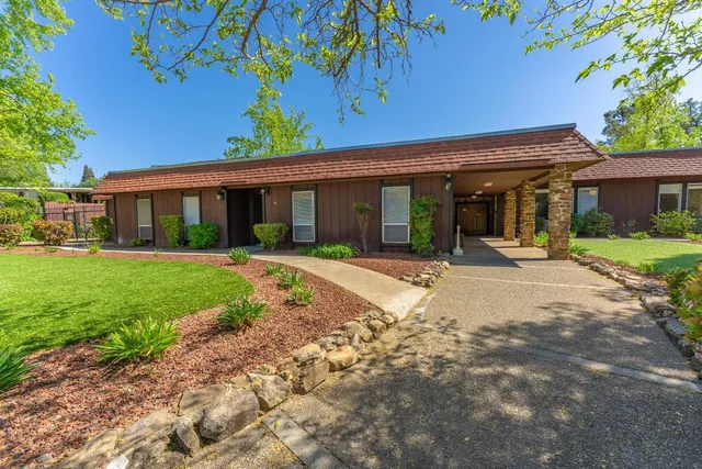 a living room with lots of furniture and a wooden floor