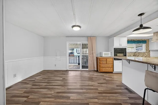 a big room with wooden floor and windows