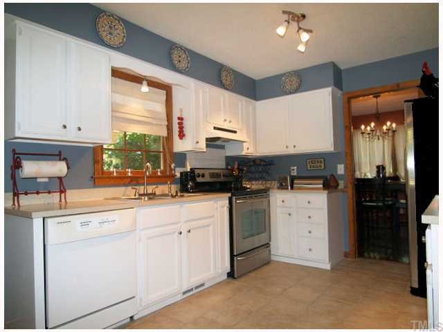6228 Lookout Loop Raleigh, NC 27612 - Photo 3 of 10 a kitchen with cabinets appliances and a window
