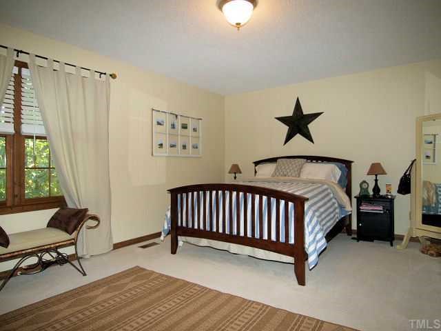 6228 Lookout Loop Raleigh, NC 27612 - Photo 7 of 10 a bedroom with a bed and a window
