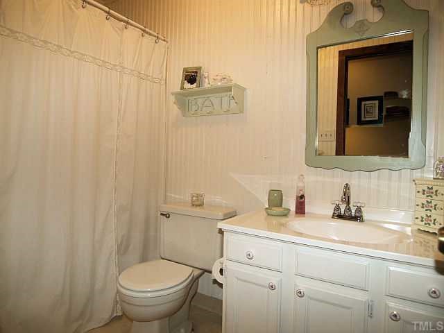 6228 Lookout Loop Raleigh, NC 27612 - Photo 10 of 10 a bathroom with a toilet a sink and mirror