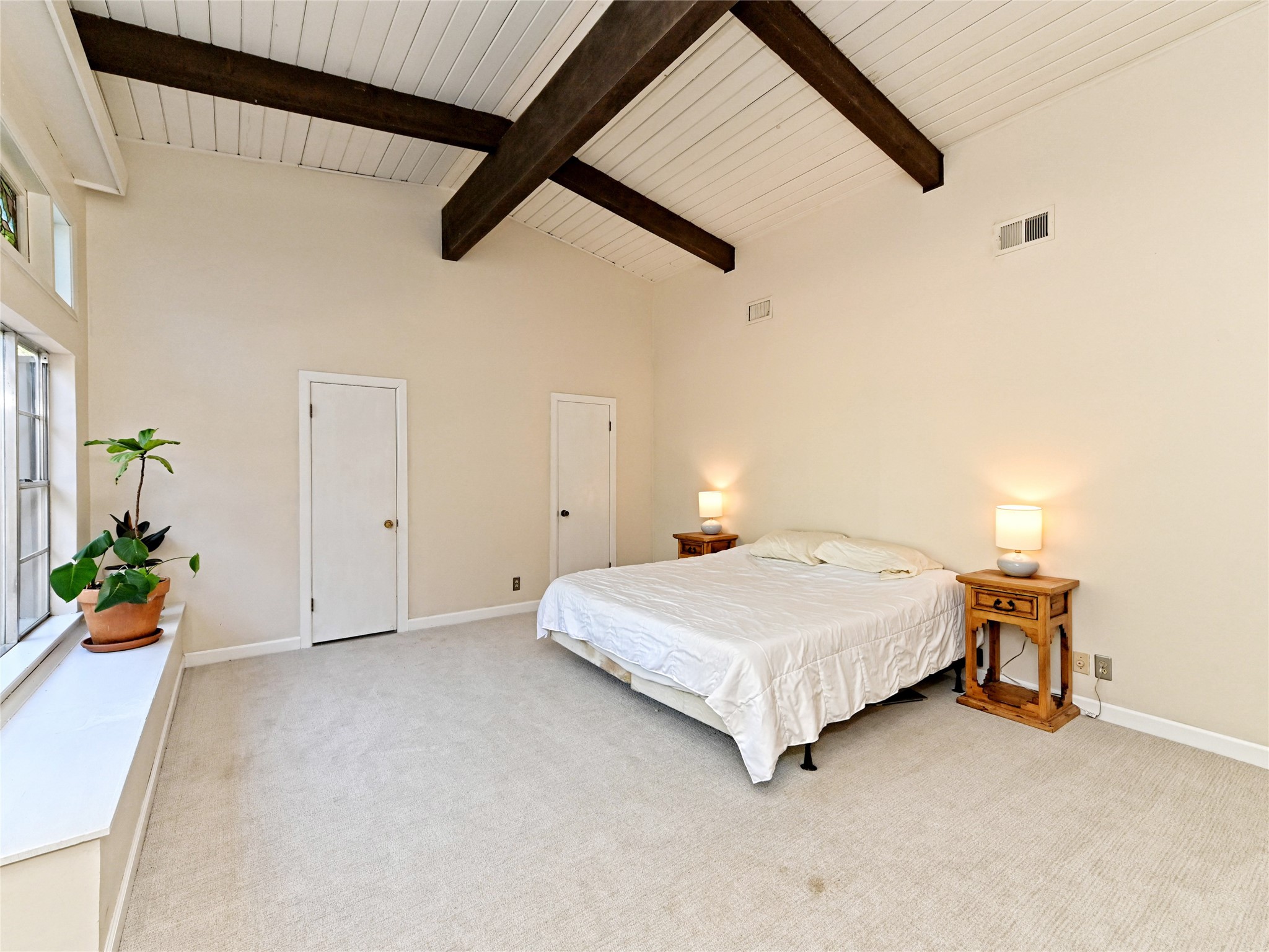 115 Snapper Street Lakeway, TX 78734 - Photo 17 of 30 A tranquil bedroom with vaulted ceilings and exposed beams offers a peaceful retreat.