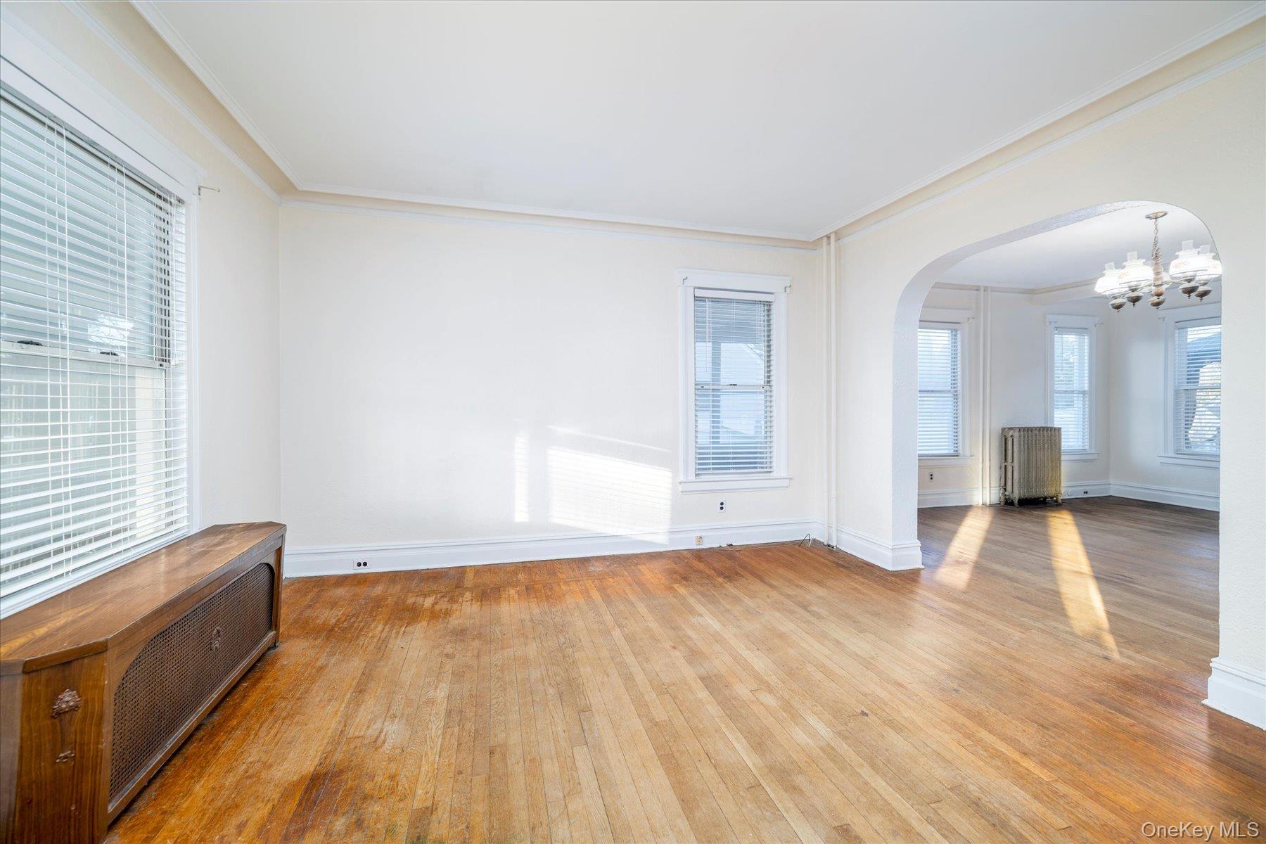 2483 Central Avenue Baldwin, NY 11510 - Photo 11 of 28 a view of livingroom with hardwood floor and a ceiling fan