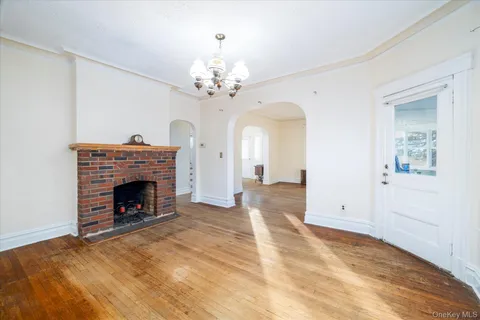 a view of an empty room with a fireplace