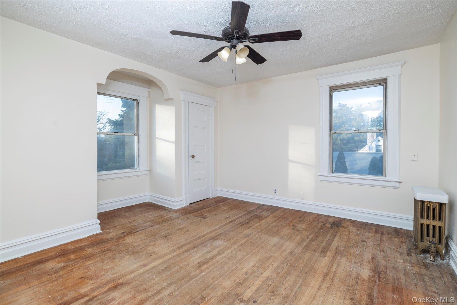 2483 Central Avenue Baldwin, NY 11510 - Photo 19 of 28 wooden floor in an empty room with a window
