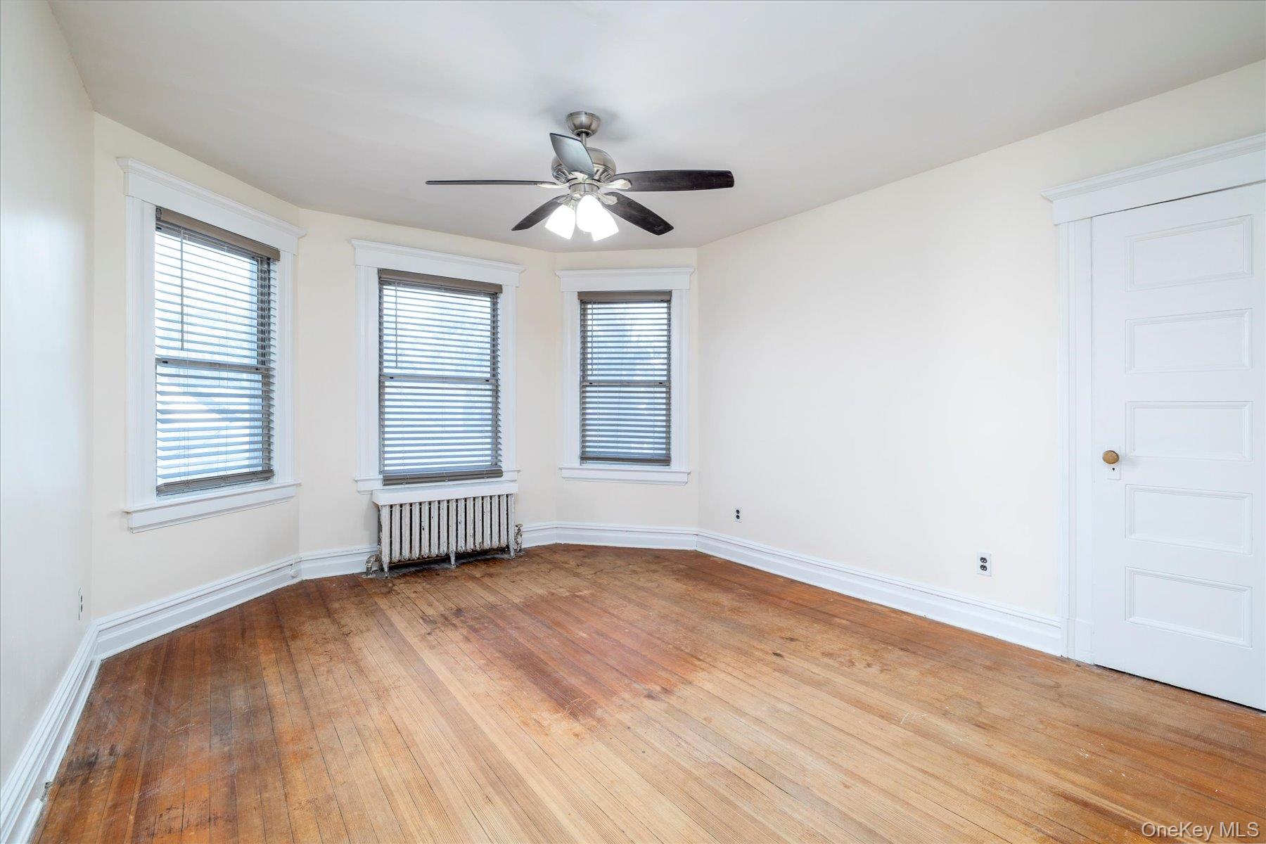 2483 Central Avenue Baldwin, NY 11510 - Photo 20 of 28 a view of empty room with wooden floor and fan