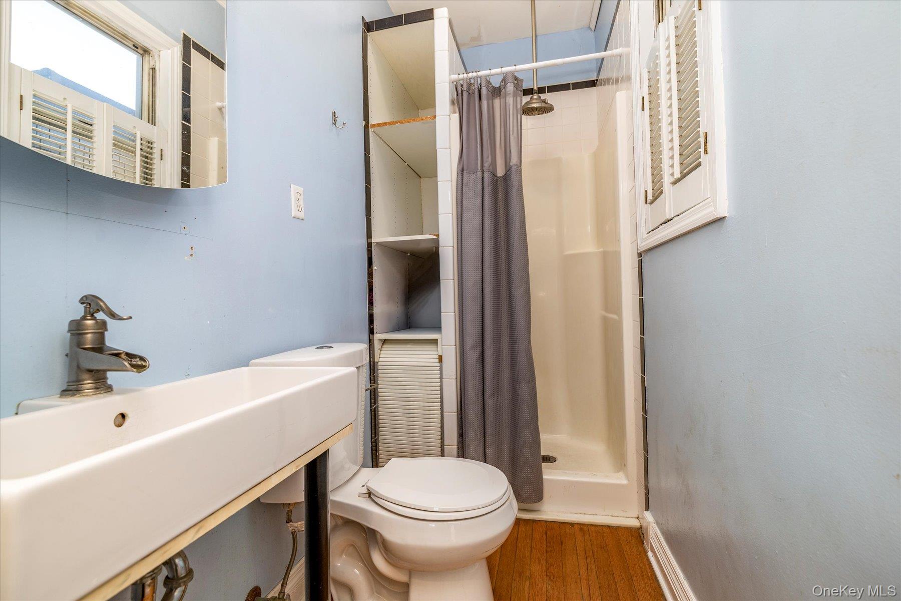 2483 Central Avenue Baldwin, NY 11510 - Photo 22 of 28 a bathroom with a sink a toilet and shower