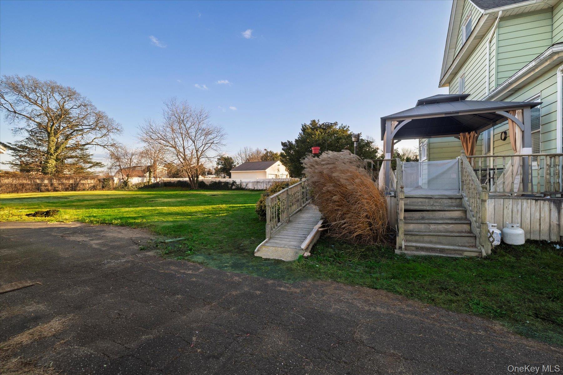 2483 Central Avenue Baldwin, NY 11510 - Photo 25 of 28 a view of a house with a yard and garage