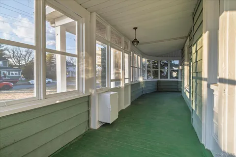 a view of a kitchen with refrigerator and windows